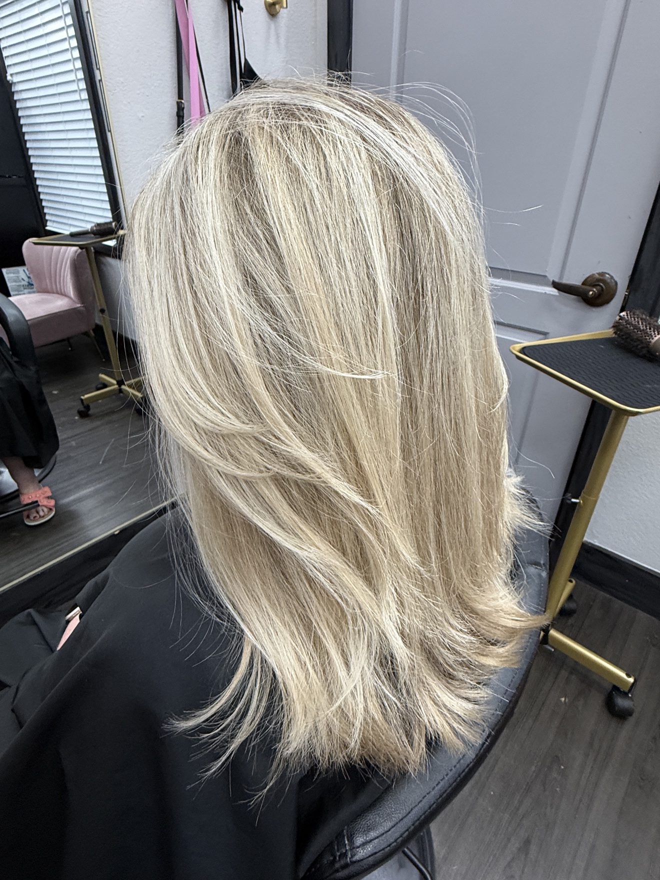Long pale blonde hair with softly flipped layers