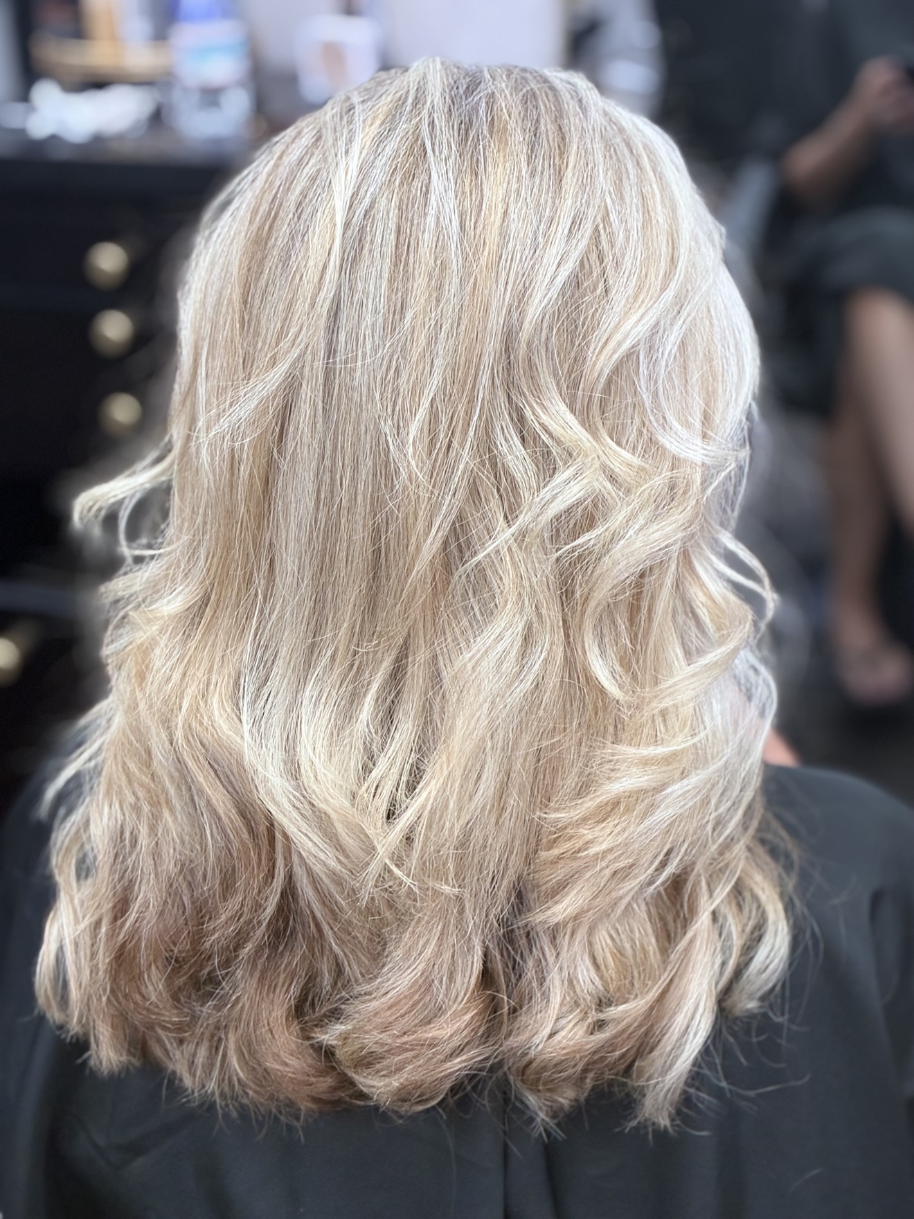 Pearl blonde hair finished with soft curls